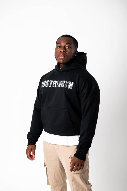 Person wearing a black hoodie with '10STRENGTH' text on a white background