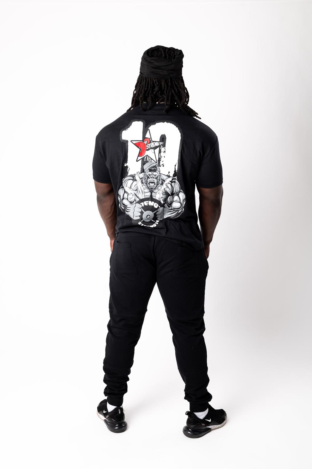 Person wearing a black t-shirt with graphic design on the back, standing against a white background