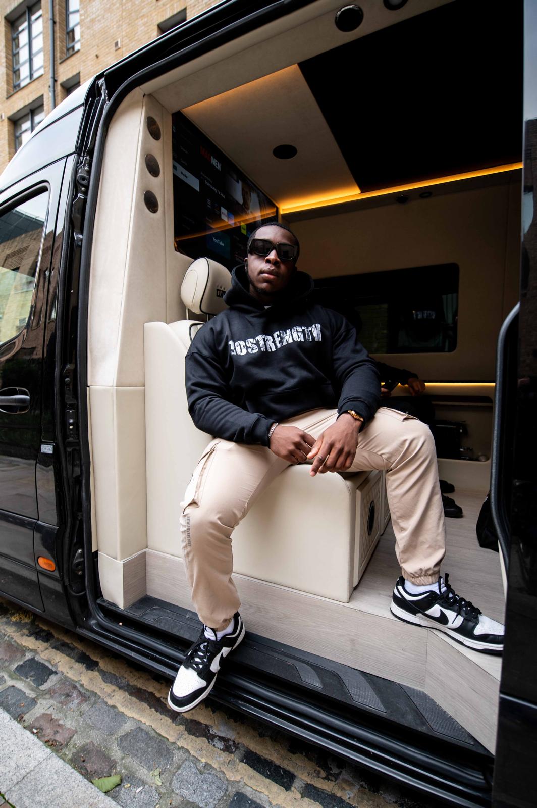 Man sitting inside a luxurious van with open door